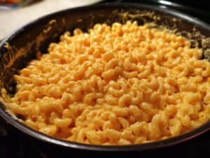 Close-up of creamy 3 ingredient stovetop mac and cheese in a black pan.