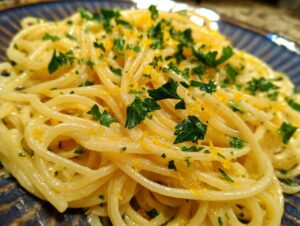 Close-up of a plate of Creamy Lemon Pasta, garnished with fresh parsley and lemon zest.