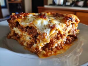 A generous slice of easy lasagna with ricotta, featuring layers of pasta, rich meat sauce, and melted cheese.
