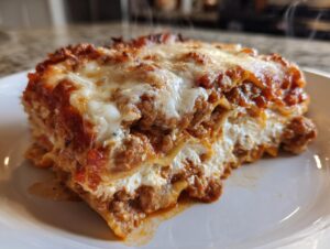 A steaming slice of delicious lasagna with cottage cheese, layered with meat sauce and melted cheese.