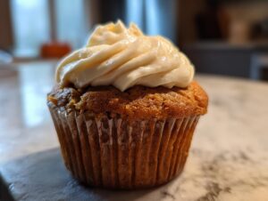 A delicious Starbucks pumpkin cream cheese muffin topped with creamy frosting.