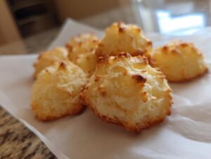 A pile of golden-brown whipped shortbread cookies with a slightly crisp exterior and soft interior.