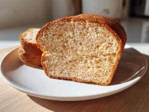 Close-up of a freshly sliced piece of soft whole wheat bread showing its fine crumb structure.
