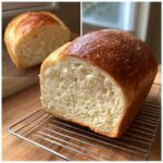 Close-up of a freshly baked loaf of fluffy yeast bread, showing the soft, white interior crumb and golden crust.